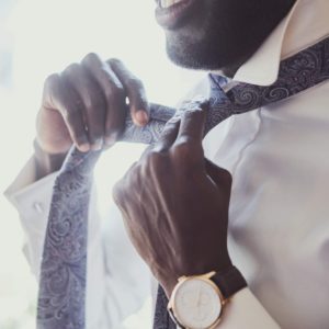 elegant-man-is-dressing-up-near-window.jpg